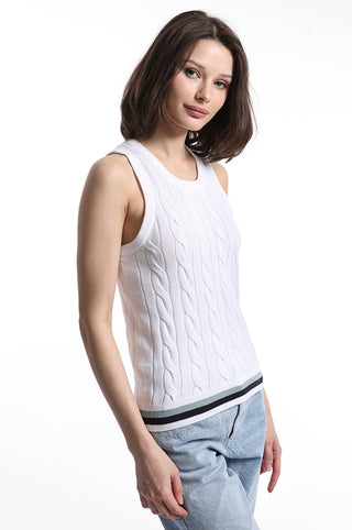 Model wearing white cable knit sweater tank top with blue white and black stripe detail on bottom hem
