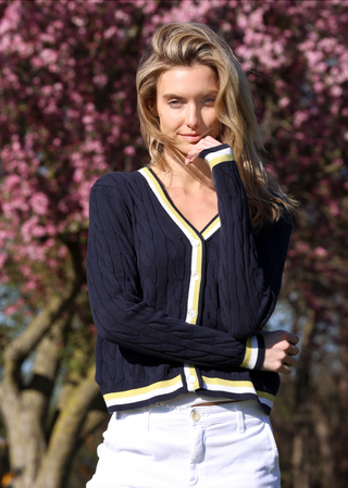 Navy cable knit cardigan with white and yellow stripes on the hem